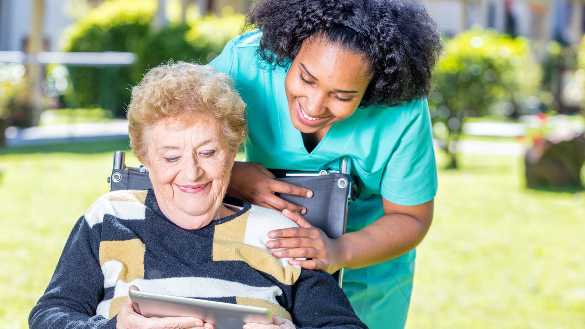 Caregiver helping a woman with a warm smile